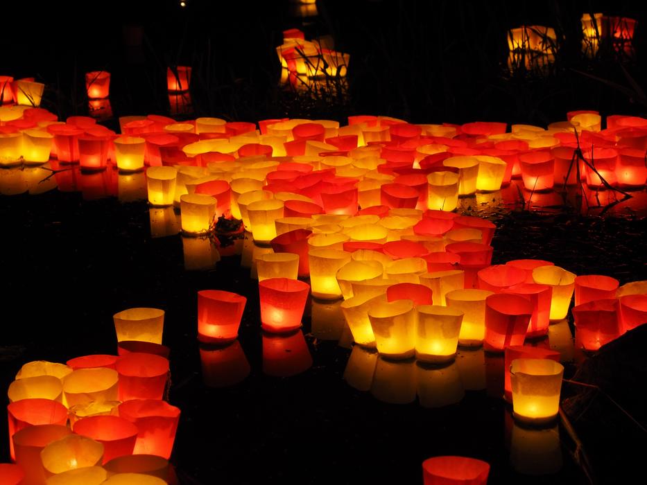 burning candles floating in the river