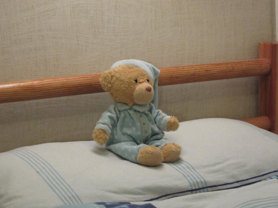teddy bear in pajamas on the bed