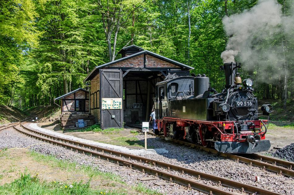 steam locomotive on the railway near the building