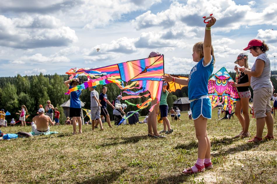 crowd of Kids with colorful kites on hill side