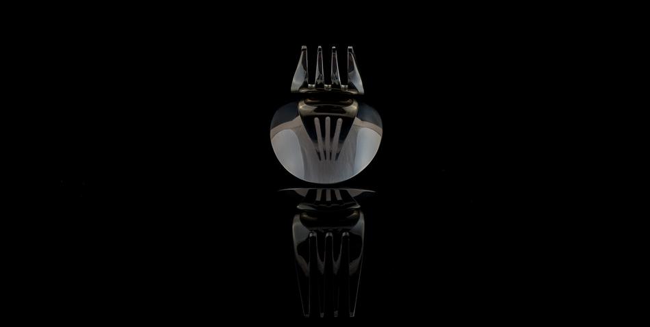 reflection of a fork on a black background