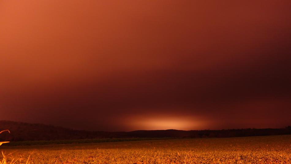 a beautiful field with an orange sunset