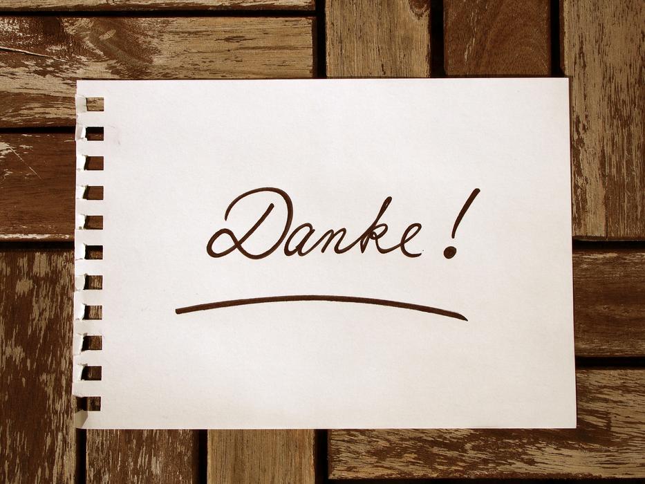 writing on paper on a wooden wall