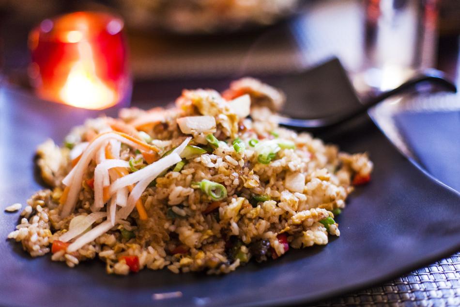 fried rice with vegetables in front of the fire