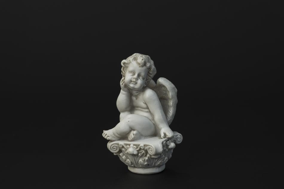 stone figure of an angel on a black background