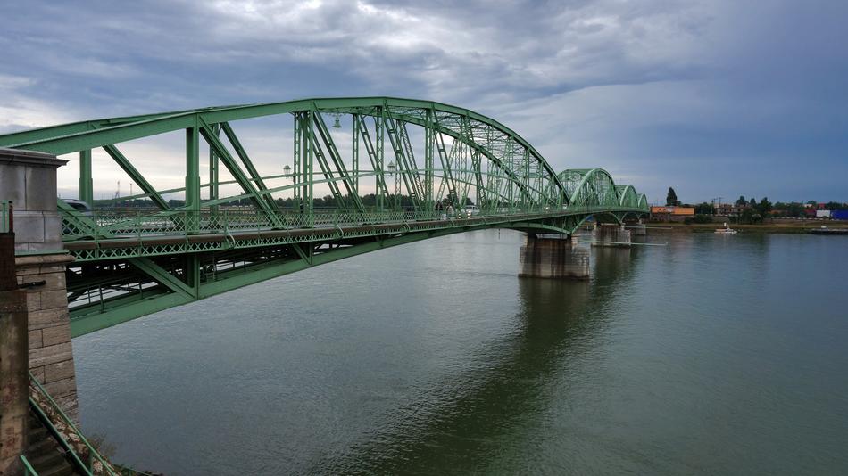 green bridge by the river in the city
