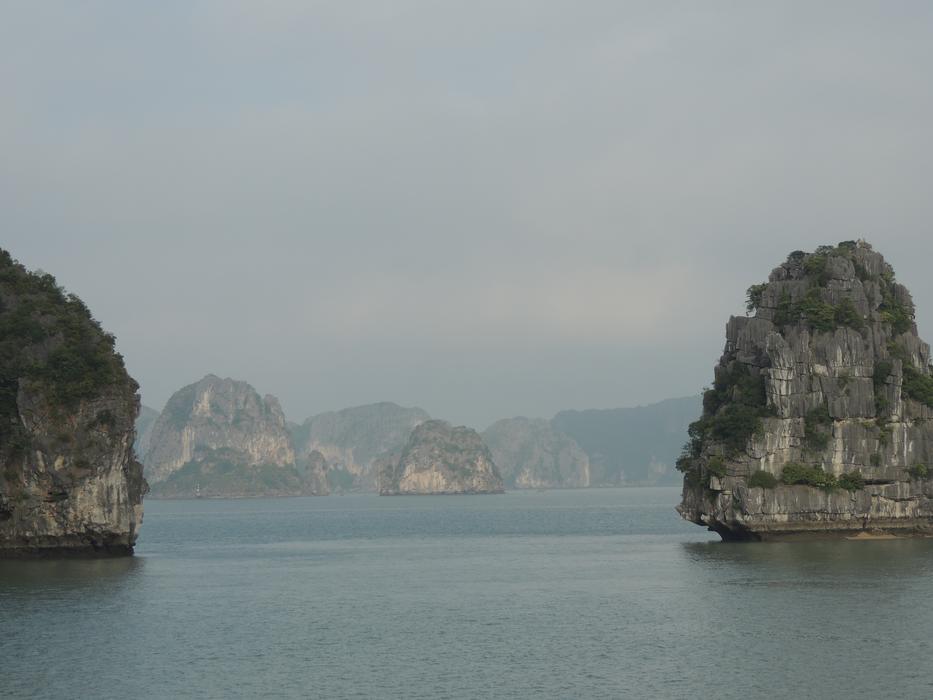 large rocks in the sea with fog