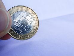 colored blank coin in hand