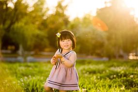 Child on grass at the sunlight