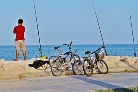 man fishing for bicycles