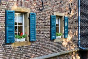 blue shutters on an old stone building