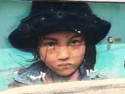 graffiti with a picture of a Mexican girl in a hat