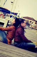 loving couple sitting on a bridge