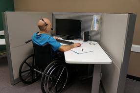 man in a wheelchair at work