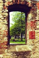 arched doorway in an old brick wall