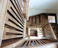 spiral wooden staircase with railing