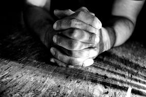 black and white photo of fingers clasped in a lock