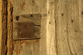 Rusty lock in a wooden door