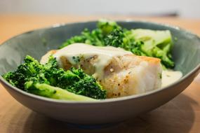 Boiled fish and broccoli in a plate