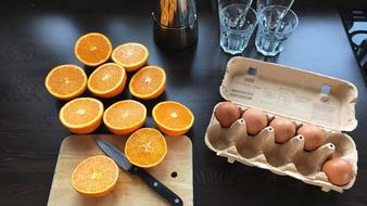 Sliced oranges and eggs in a box