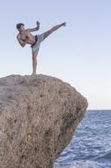 Karate training man on Beach cliff