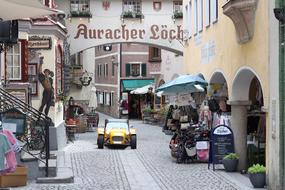 little yellow car on a colorful street