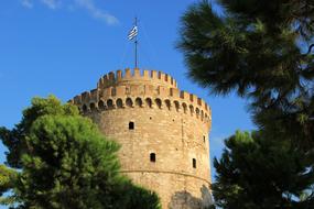 Thessaloniki tower among the green trees