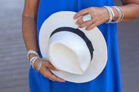 girl holding straw hat