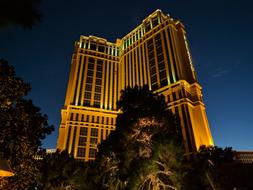 apartment building illuminated by lights at night