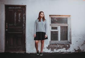 girl near the door and house wall