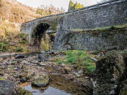 Side view of the stone bridge by the river
