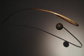 wooden hinged sculpture with a ball