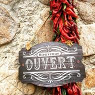 wooden board with signature and peppers