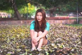 girl sitting on a leaf
