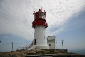 white lighthouse with a red roof