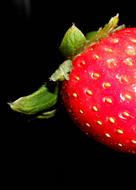 juicy strawberries on a black background