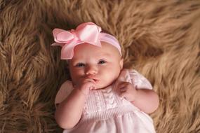 cute baby in a shawl with a flower