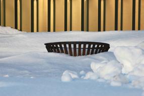 iron basket in the snow for a campfire