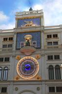 photo of a golden clock on a building in Venice