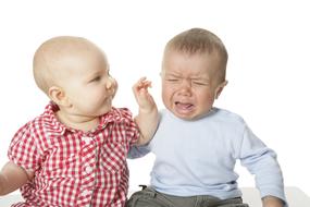 a toddler touches another toddler
