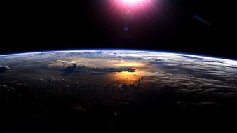 burning sun over the earth in space