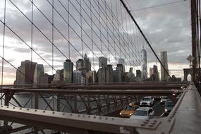 Beautiful Brooklyn Bridge in New York under cloudy sky in USA