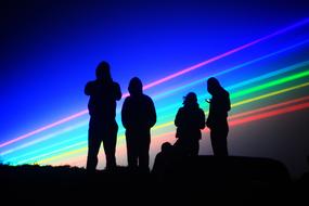 silhouettes of people on a colored background