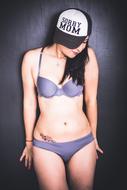 Sexy Woman in bikini at wall