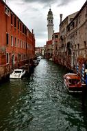 boats on the canal near buildings in venice