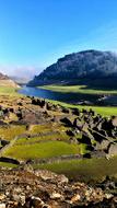 old ruins by the river and mountains