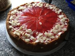 Greeting sweet cake decorated with nuts