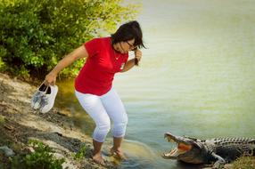 frightened woman near a crocodile