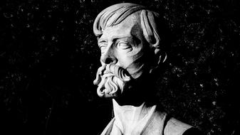 stone bust of a man with a mustache and beard