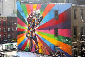 colorful graffiti in the form of a kissing couple on a wall in New York